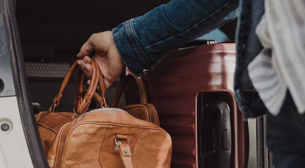 Man with bag at car