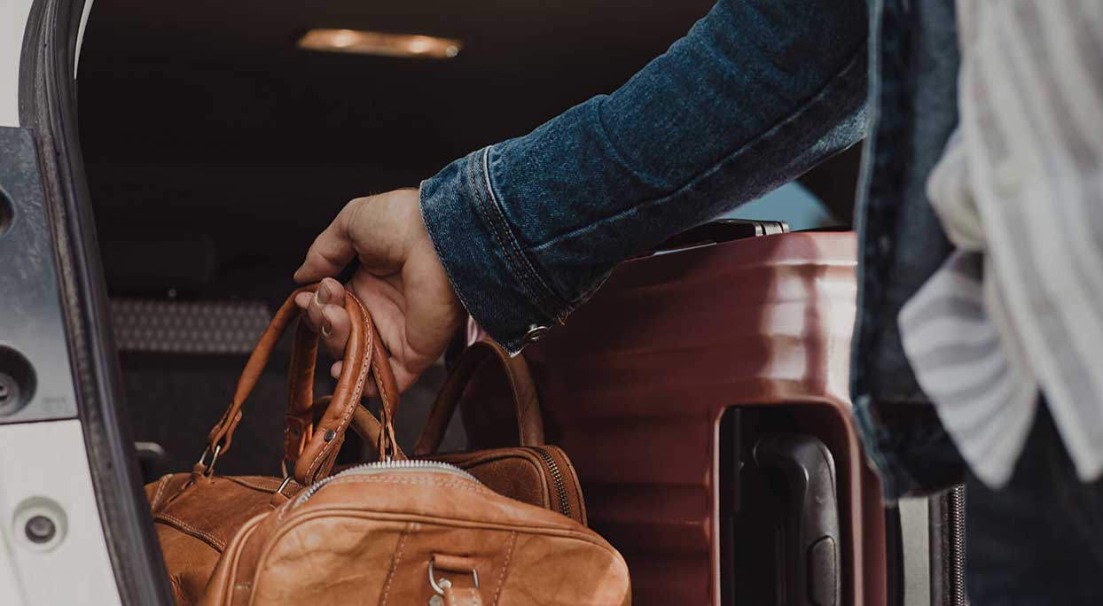 Man with bag at car